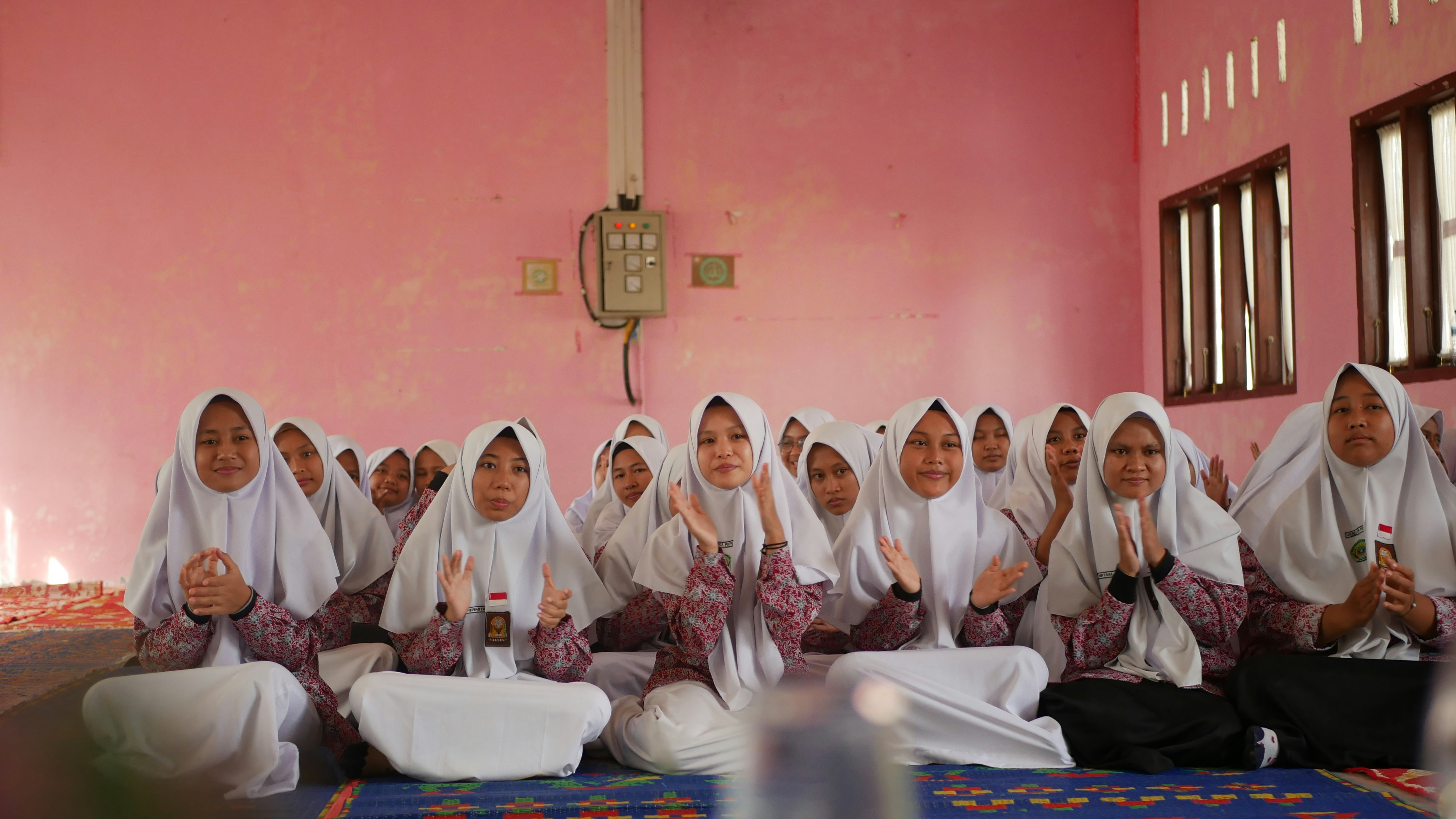 a group of women sitting on top of a floor